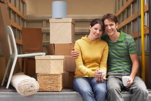 Professional Brentcross movers packing household items into secure boxes