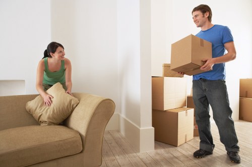 Removal team navigating stairs during a flat move in Brentcross